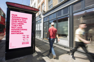 Out-of-home advertising example showing a digital billboard at Shoreditch High Street Station with a bold pink poster campaign, illustrating how SMEs can use high-footfall urban locations to build brand awareness.