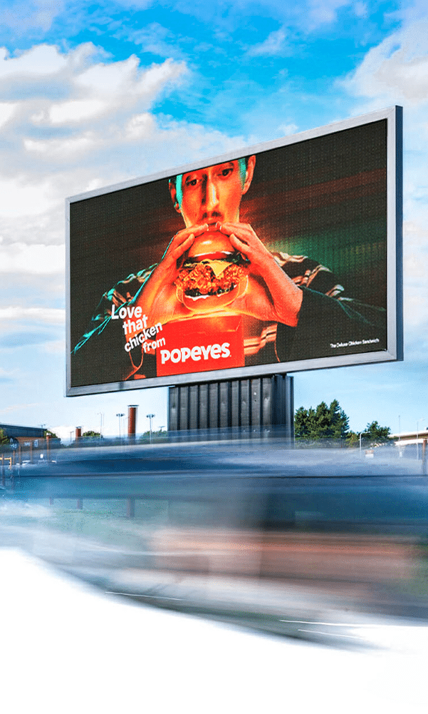 An Elonex Digital Out of Home billboard advertising display for Popeyes fast-food restaurants